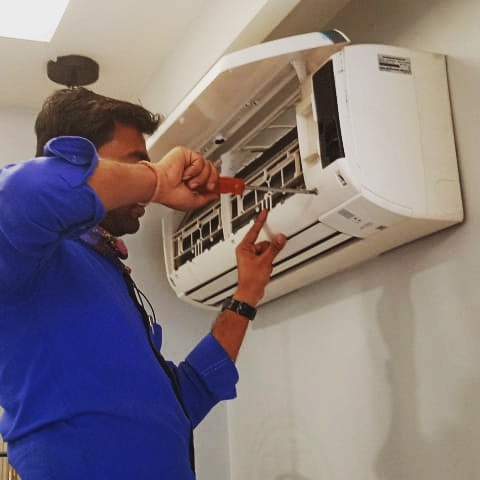 Technician repairing AC unit